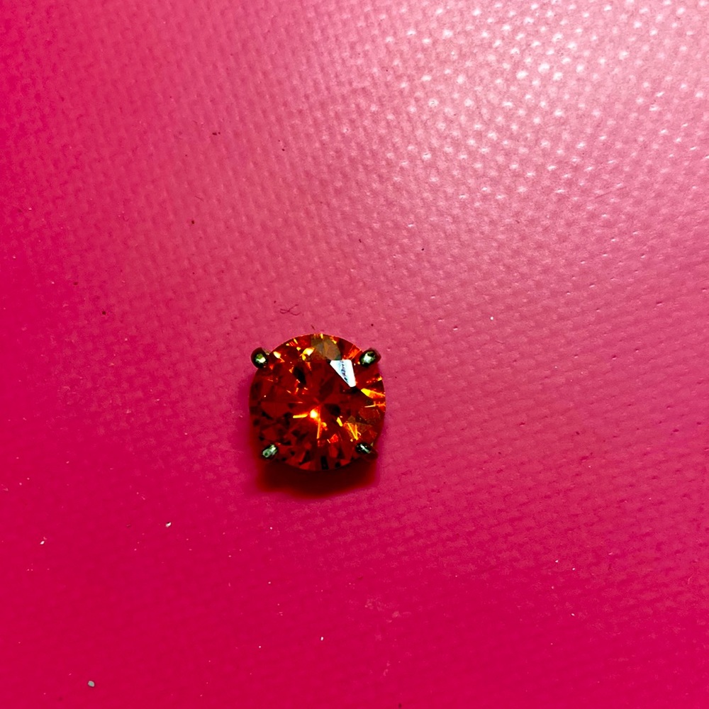 I am selling a ruby with a little ring/hoop around it.
